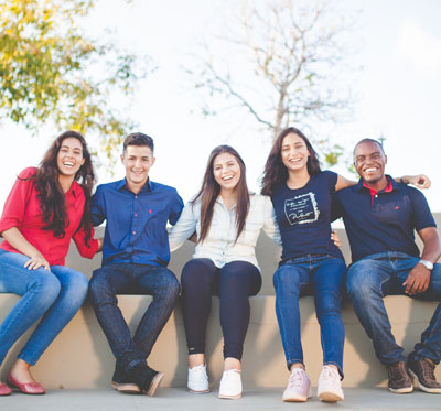 A group of young men and women laughing together