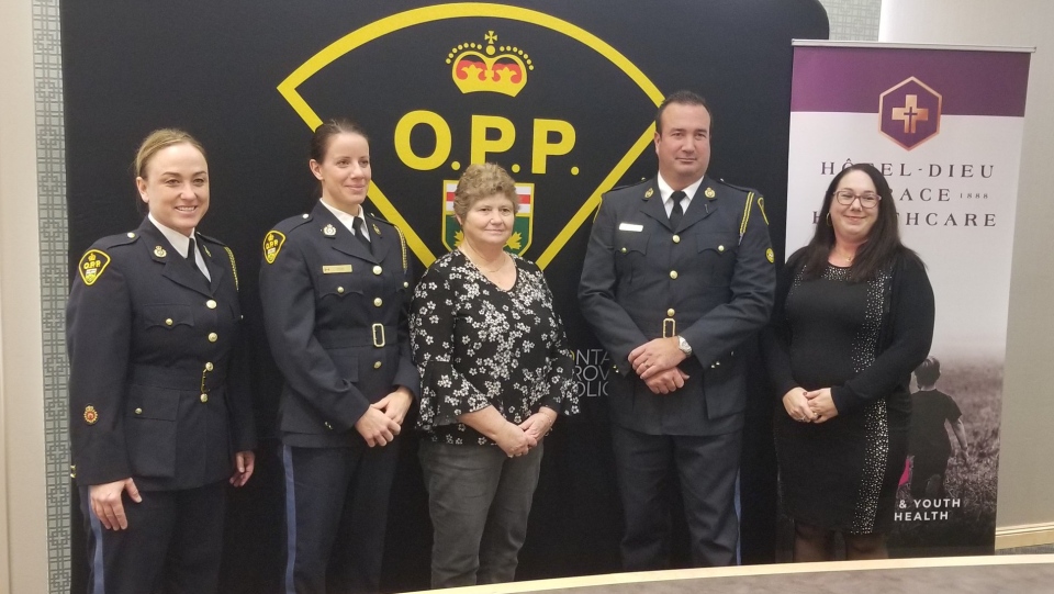 Representatives of Hotel-Dieu Grace Healthcare stand with OPP Officers