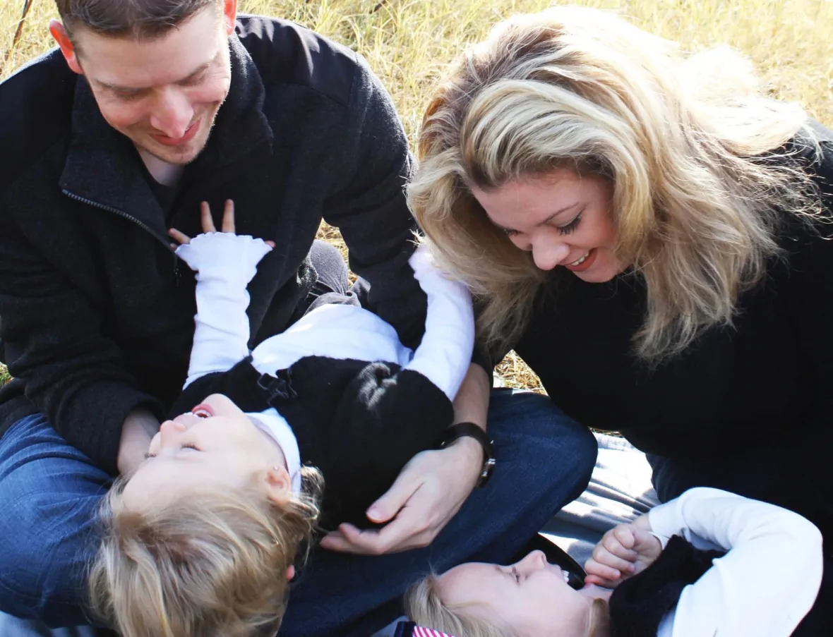 Froede and Kemplin playing with their two daughters